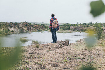 Man with backpack hiking in the mountains