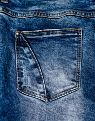 Denim. Back pocket on blue jeans.  Clothes.