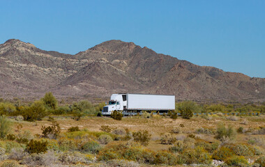American make big rig semi truck transporting reefer fast on mountain highway