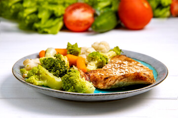 A plate with diet food. Vegetables and baked turkey