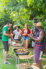 Obraz premium Group of friends having fun and happy in barbecue party at house backyard