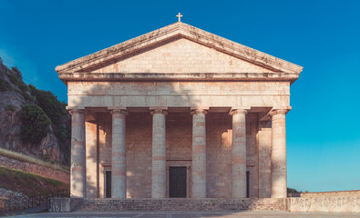 Fototapeta na wymiar old greek temple in corfu with clear blue sky