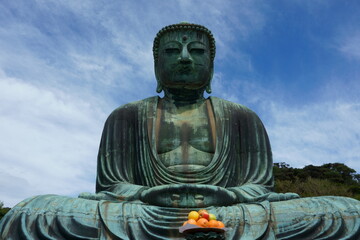 Great Buddha of Kamakura, a monumental outdoor bronze statue of Amitabha. Sitting Buddha at sky background