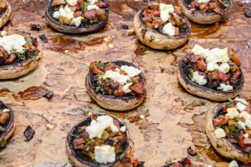 Cooked mushrooms stuffed with vegetables, cheese and meat