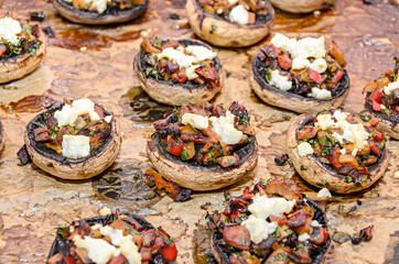 Cooked mushrooms stuffed with vegetables, cheese and meat