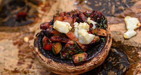Fototapeta premium Cooked mushrooms stuffed with vegetables, cheese and meat