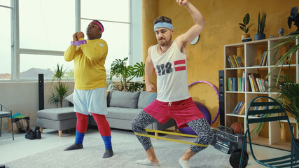 Funny sport freaks wearing retro style clothes and doing wrong stretching exercises with elastic...