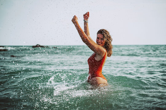 Chica playa bañador verano cadiz sur españa alegre feliz disfrutando de vacaciones libertad joven baño mar agua