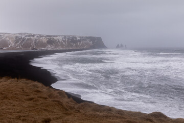 storm on Iceland's black beach and winter Atlantic Ocean