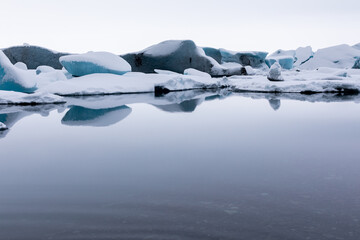 Panorama water on Winter Jokulsarlon Glacier is an icy beach where ice floes float