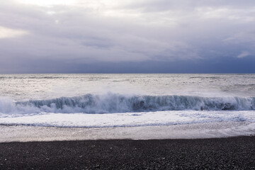 Reynisfjara black beach and the waves of the winter Atlantic Ocean