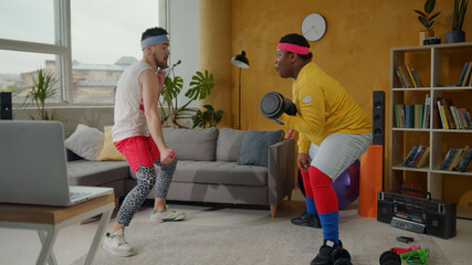 Funny couple of sportsmen performing fitness parody, playing the dumbs, having fun training on...