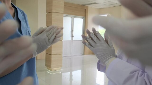 slow motion closeup hand applaud from doctor and nurse support,Clapping medical workers blur hospital background  zoom motion view