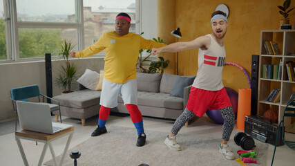 African american fat guy engaged in sports with fitness instructor doing light stretching warm-up exercises indoors. Funny workout. Training. Fun concept.