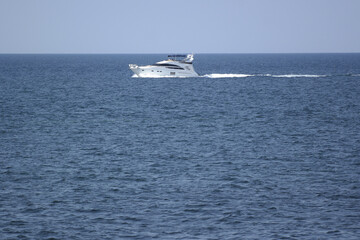 white yacht goes on the sea on the horizon
