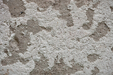 Stripped concrete wall texture with cracks and scratches. Fragment of old wall, for background or texture.