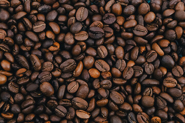 Coffee grains. Background of roasted coffee beans brown. layout.