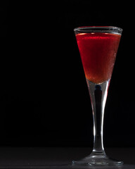 Shot glass containing red drink