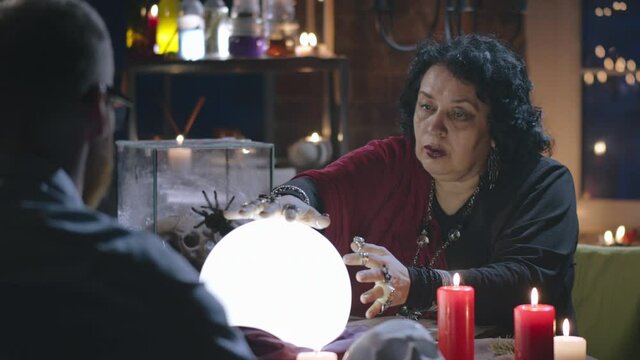 A person sitting at a table in front of a cake