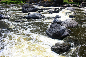 Boulders lie in a mountain river