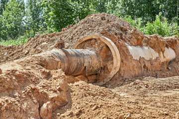 Reconstruction of the water supply network. An old water pipe in a reinforced concrete sleeve was...