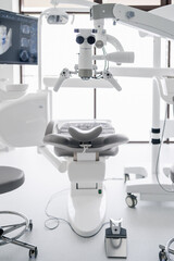 Interior of dental practice room with chair, lamp, display and stomatological tools