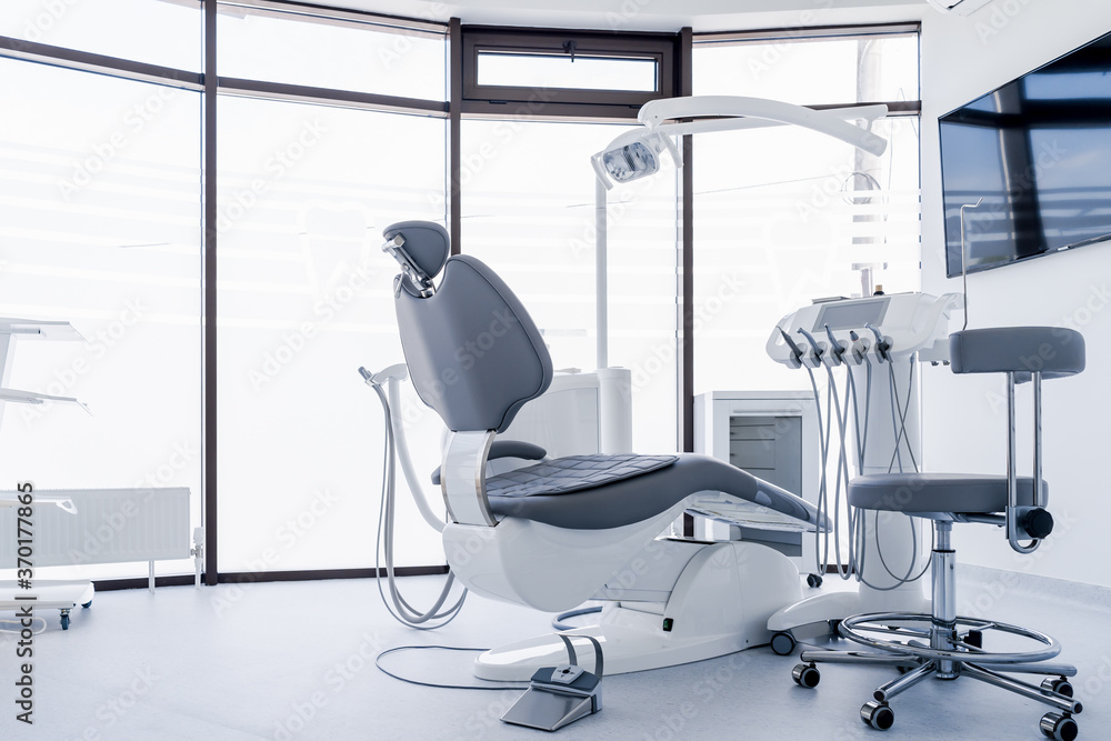 Wall mural interior of dental practice room with chair, lamp, display and stomatological tools