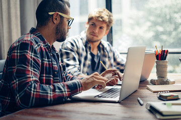 Group of young people working together. Creative business people in modern office. Hipster team in coworking. Young modern colleagues.