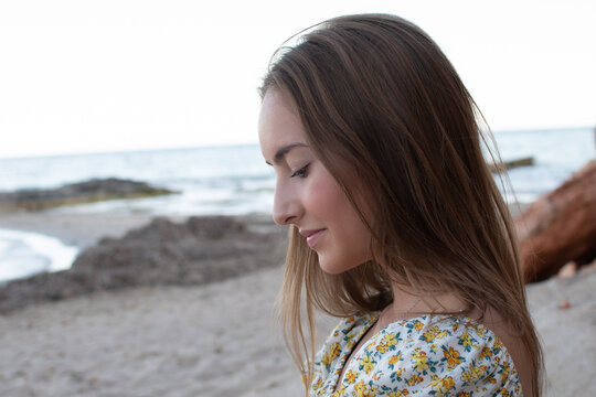 Profile of a pretty girl on the beach
