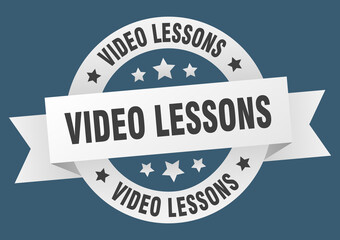 video lessons round ribbon isolated label. video lessons sign
