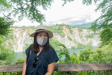 Fototapeta na wymiar Young Asian traveler woman wearing face mask while traveling.