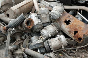 A pile of used auto parts and machinery in close-up.