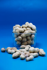 Fototapeta na wymiar Peanuts on a blue background. A handful of peanuts. Nuts, correct, healthy food