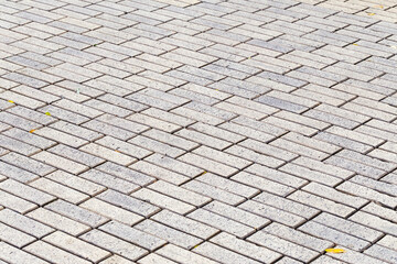 Decorative colorful sidewalk pavement. Tiled floor with grey tiles crossed by a diagonal double...
