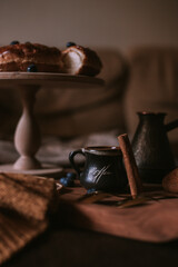 Still life of apple pie, berries, coffee and lemons on wooden tray