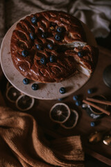Still life of apple pie, berries, coffee and lemons on wooden tray