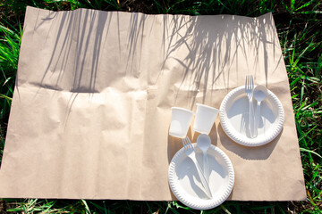 two sets of disposable biodegradable tableware for an outdoor picnic. cornstarch forks, spoons,...