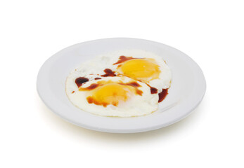 fried eggs in the place with soybean sauce on white