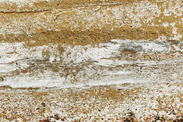 Great colorful background or texture. Abstract concrete is aged with cracks, scratches and remnants of old paint in different shades. Rough concrete surface