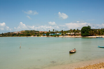 Tropical beach in Thailand with blue ocean, white sand and typical fishermen boat