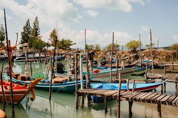 Colourful fishing boat and canoes in Thailand