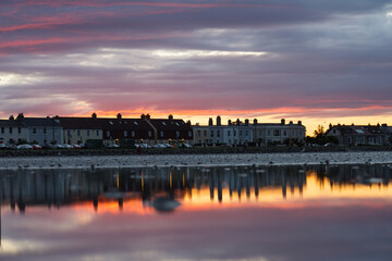 Cityscape, Sunset behind townhouses, reflection in the water, Sandymount, Dublin, Ireland
