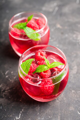 Raspberry and mint cocktail in glass on the rustic background. Selective focus. Shallow depth of field. 