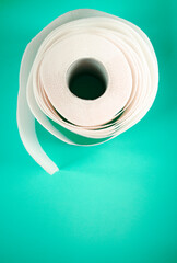 Advertise banner with toilet paper and copy space. Paper towel roll on turquoise background. Hygiene stuff for everyday and body care products.