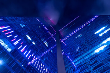 Two skyscrapers against a dark sky. Modern city in the evening.
