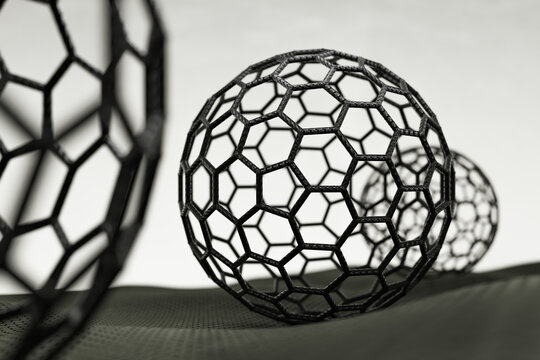3D rendering of fullerene spheres on white background, black atoms and bonds
