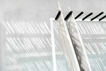 Rack with two surf boards on gray concrete background with beautiful day sun light. Active...