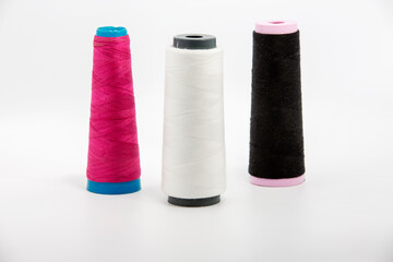 Antique spools of thread multicolored on a white background room for copy space