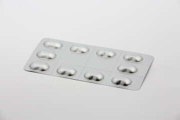 Heap of medical pills in white, orange and other colors. Pills in plastic package. Concept of healthcare and medicine.