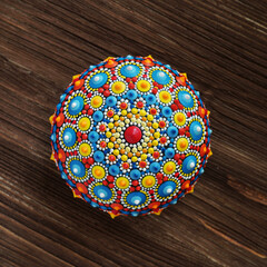 beautiful mandala rock on wood background